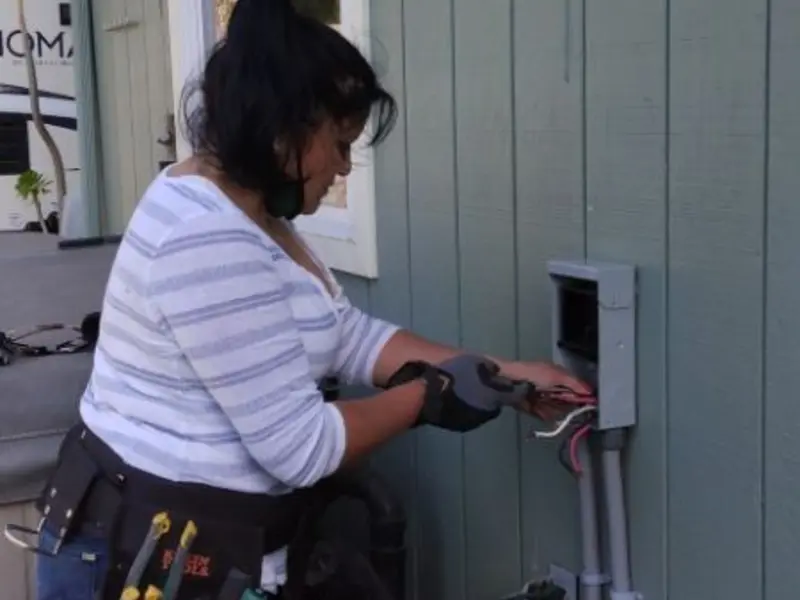 Licensed electrician wiring an exterior subpanel in Oakhurst